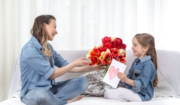 mother-s-day-little-daughter-with-flowers-congratulates-her-mother